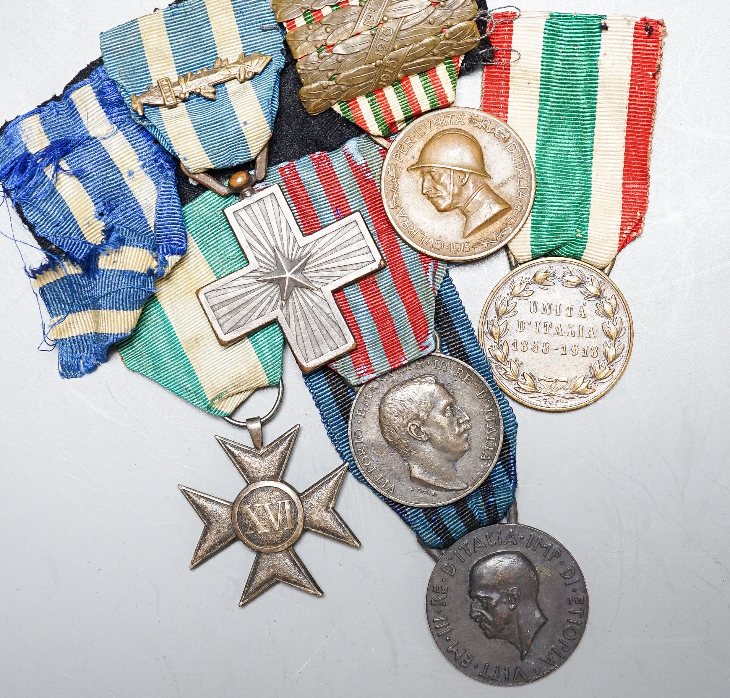 An Italian WWI medal group of six, including War Cross, War of Italian independence 1915–18 with four clasps, Libya 1911, United Italy 1848-1918, Ethiopian campaign 1935 and Army long service medal